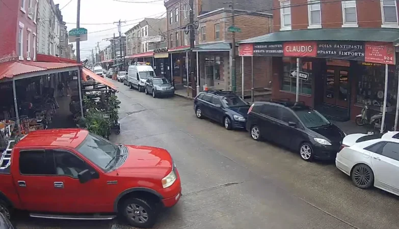 A scenic street view in Bella Vista, Philadelphia, PA, showcasing charming row homes, tree-lined sidewalks, and a vibrant, walkable neighborhood atmosphere.