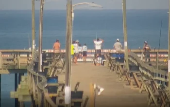 Live HD webcam view of Nags Head Pier showing ocean waves, fishing activity, and changing coastal scenery throughout the day.