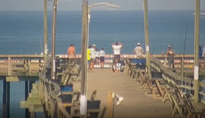 Live HD webcam view of Nags Head Pier showing ocean waves, fishing activity, and changing coastal scenery throughout the day.