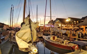 Bowen's Wharf in Newport, Rhode Island with sailboats docked beside waterfront restaurants and shops