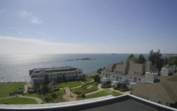 Water’s Edge Resort waterfront with calm ocean waves and bright blue sky