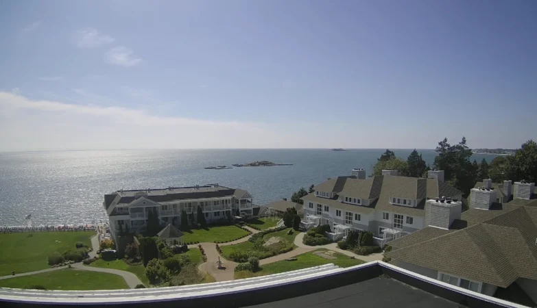 Water’s Edge Resort waterfront with calm ocean waves and bright blue sky